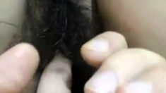 Ebony female fingering her hairy pussy